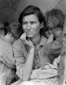 A black-and-white portrait of a weary woman with two children, reflecting themes of hardship and resilience during the Great Depression.